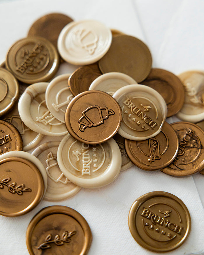 Collection of wax seals with 'Brunch' and other designs on a white background