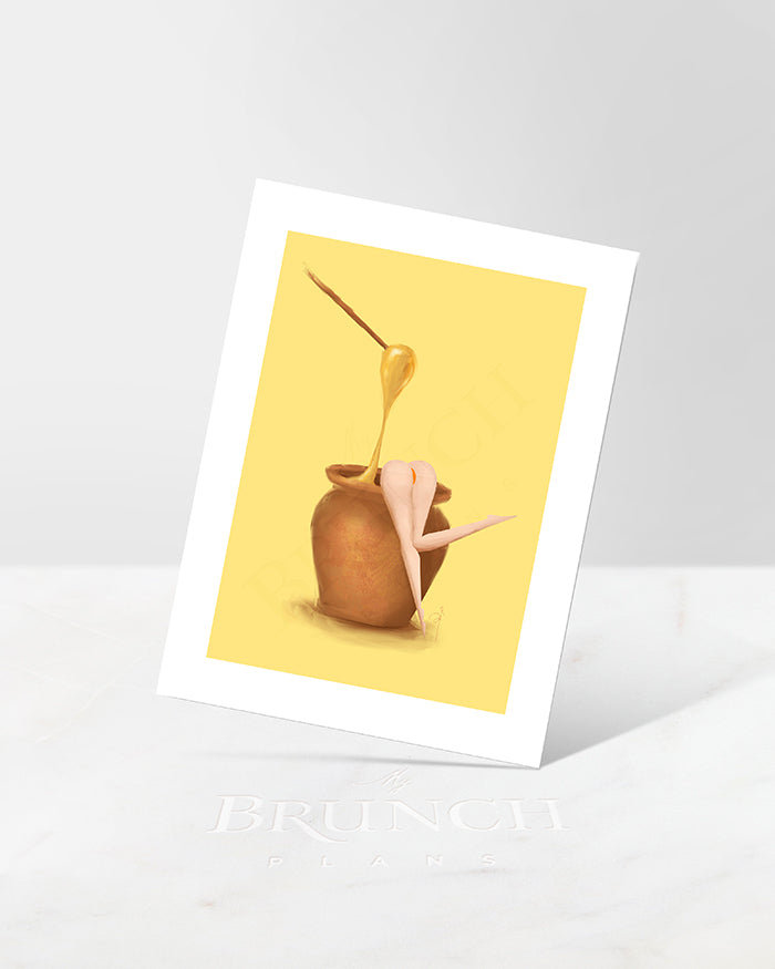 An art print featuring an illustration of a woman in a honey jar with a bee, set against a yellow background.