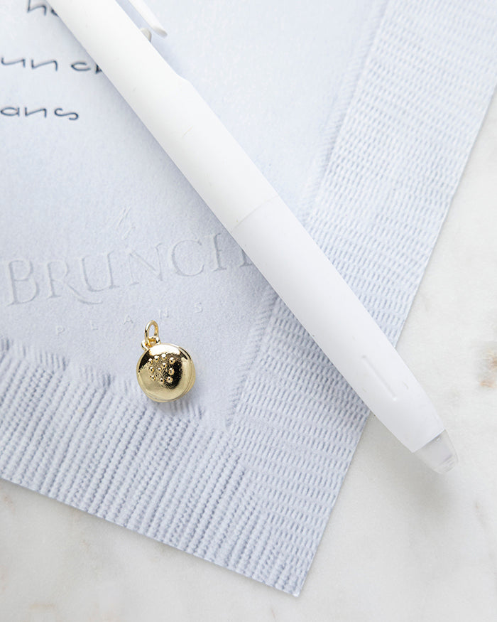 Hamburger Charm | 16k Gold Plated on My Brunch Plans’ Napkin notepad with a pen for size comparison.