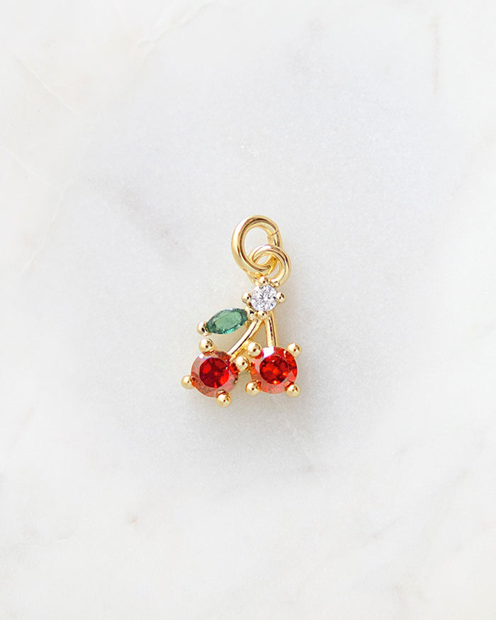 My Brunch Plans' Cherry Charm | 18k Gold Plated with CZ on a marble background, perfect for planners, notebooks and more.