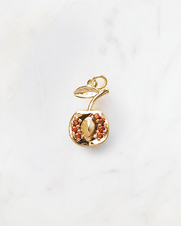 My Brunch Plans' Nectarine Charm | 18k Gold Plated with CZ on a marble background, perfect for planners, notebooks and more.