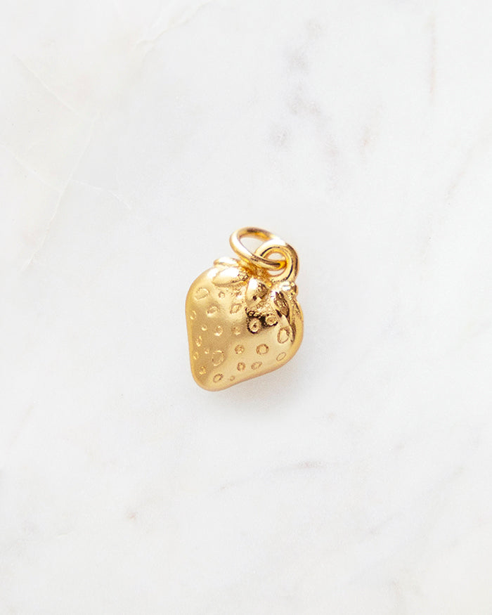 My Brunch Plans' Dainty Strawberry Charm | 24k Gold Plated on a marble background, perfect for planners, notebooks and more.