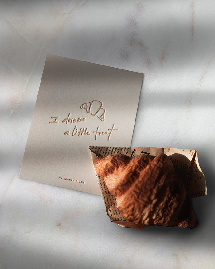 Baked pastry with a card on a marble surface