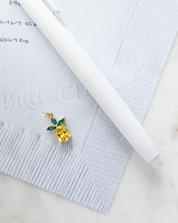 Pineapple Charm | 18k Gold Plated on My Brunch Plans’ Napkin notepad with a pen for size comparison.
