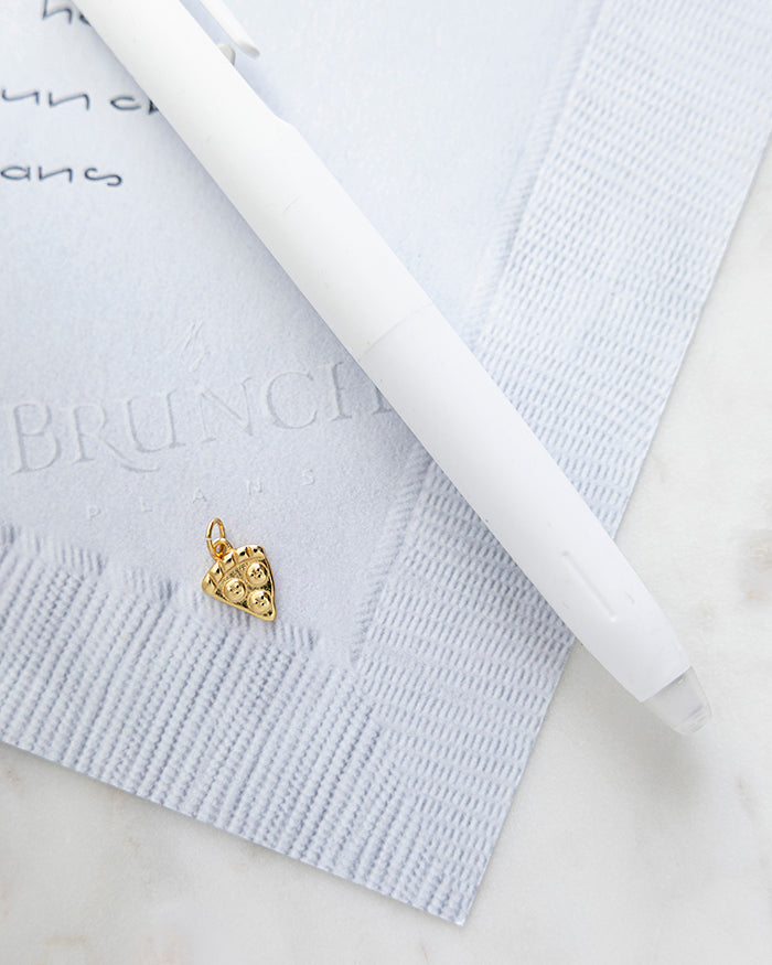 Pizza Charm | 24k Gold Plated on My Brunch Plans’ Napkin notepad with a pen for size comparison.