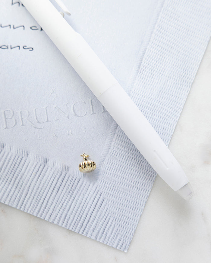 Pumpkin Charm | 18k Gold Plated on My Brunch Plans’ Napkin notepad with a pen for size comparison.