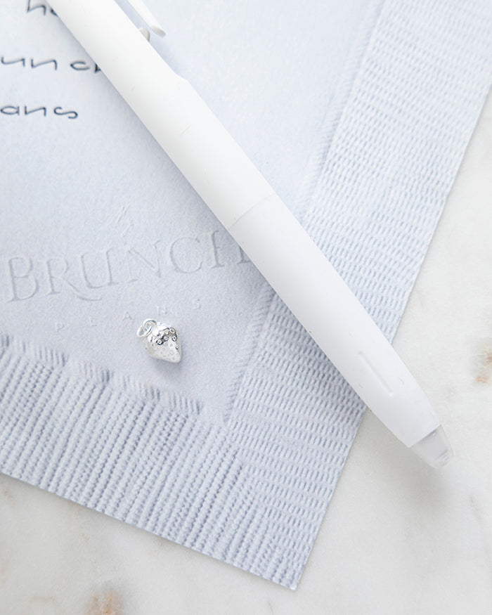 Strawberry Charm | Silver on My Brunch Plans’ Napkin notepad with a pen for size comparison.